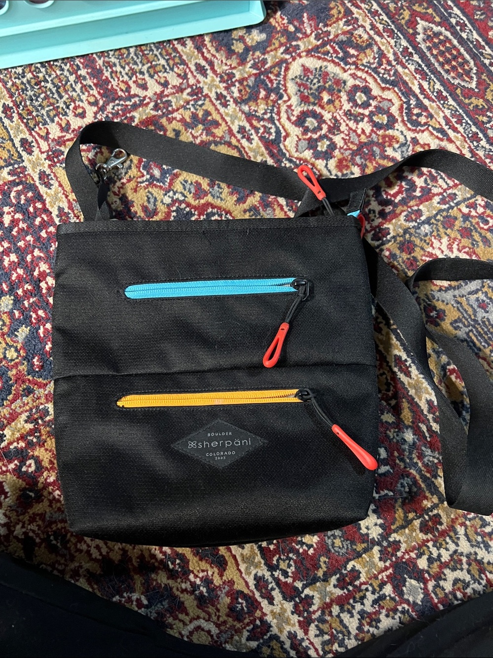 Sherpani Black Messenger Bag with Blue and Yellow Zippers